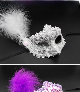 Detail of silver and purple masquerade masks with intricate lace and fluffy feathers