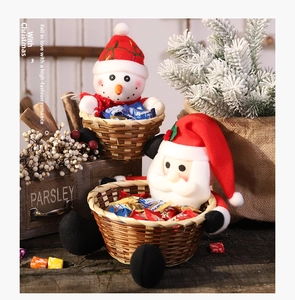 Festive Christmas candy baskets featuring plush Santa and snowman characters on a rustic table.