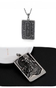 Detailed relief of Guan Gong on a vintage stainless steel pendant with intricate engravings