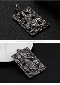 Macro detail of Guan Yu relief on vintage stainless steel pendant with embossed patterns