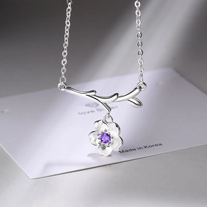 Elegant silver flower necklace with branch pendant and purple zircon stone