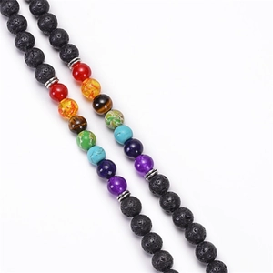 Detailed macro view of 108 lava rock beads and colorful chakra stones on the yoga bracelet