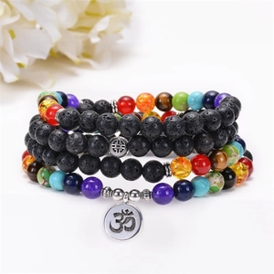 Detail of 108 lava stone prayer beads with colorful natural stones and Om charm