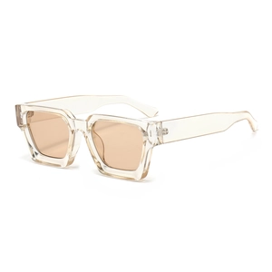 Detail view of champagne square sunglasses featuring thick frames and tinted lenses