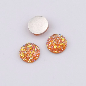 Macro detail of 10mm orange resin druzy cabochons with flat silver back for DIY jewelry