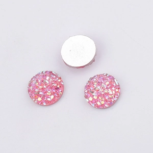 Macro detail of 10mm pink resin druzy cabochons with iridescent glitter for DIY jewelry