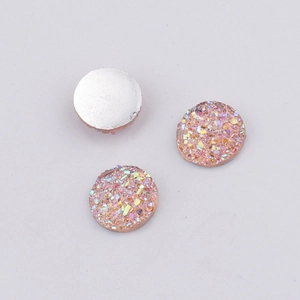 Close-up of 10mm pink resin druzy cabochons with sparkling crystals and silver flat back