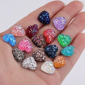 Handful of 12mm heart shaped resin druzy gems in various glitter colors for DIY crafts