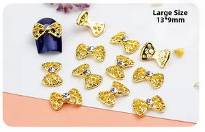 Detailed close-up of 13x9mm golden hollow bow nail art alloy charm with center rhinestone