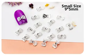 Detail of 9x5mm silver bow nail art charms with hollow design and inlaid crystal rhinestones