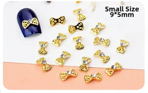 Detail of 9x5mm small gold hollow bow nail art alloy charms with central rhinestone