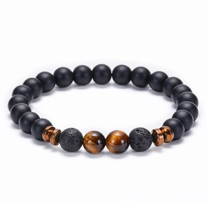 Macro detail of natural lava rock and tiger eye stone beads on a stretch bracelet