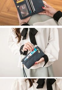 Detail view of the deep blue long wallet showing multiple card slots and wristlet strap