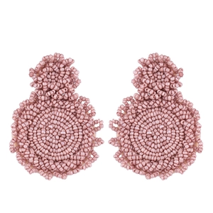 Detail of pink handmade beaded bohemian earrings with intricate layered circular texture
