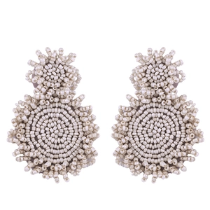 Detail of handcrafted cream beaded earrings with vintage geometric weaving and gold finish