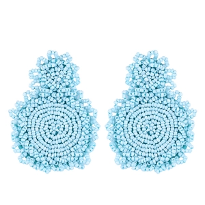 Detailed view of light blue handmade seed bead earrings with bohemian geometric weaving