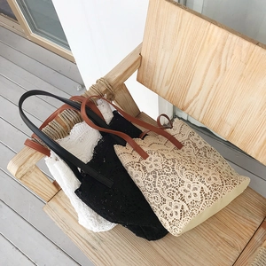 Three colors of floral lace bucket bags with leather straps shown in a group set