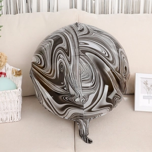 Detailed view of round marble pattern balloon with realistic ink texture on a sofa