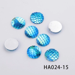 Detailed view of 16mm blue mermaid scale resin flatback cabochons with iridescent finish