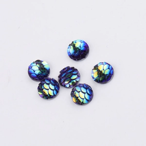 Macro detail of 8mm round resin fish scale cabochons with iridescent AB rainbow effect