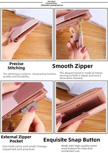 Detail view of pink bicolor short wallet featuring tassel zipper and card slots