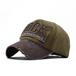 Detail of vintage washed cotton baseball cap with ROCK embroidery and distressed edges