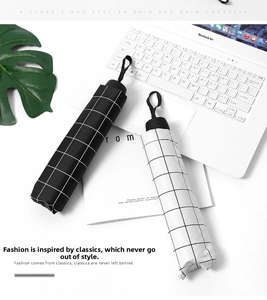 Detailed view of compact black and white checkered umbrellas on a modern desk setup