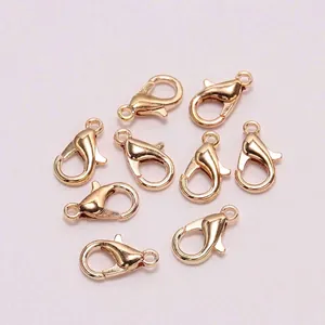 Close-up of nine KC Gold lobster clasps for DIY jewelry making on purple background
