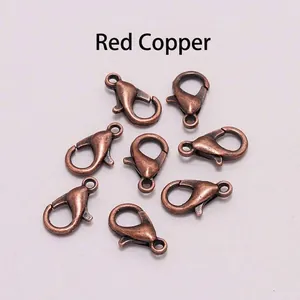 Macro shot of 8 vintage red copper alloy lobster clasps for DIY jewelry making and crafts