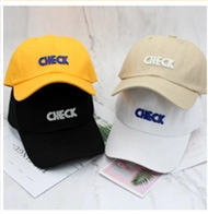 Macro view of four colorful cotton baseball caps with bold CHECK embroidery