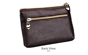 Detail view of the back of a dark brown leather coin purse with heart-shaped zipper pull