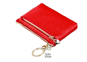 Side view of red pebble leather coin purse featuring gold double zippers and heart pendant