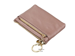 Detail of pink lychee leather coin purse with double zippers and golden heart keychain