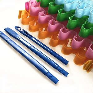 Close-up of colorful wave magic curlers with blue styling hooks on a white background