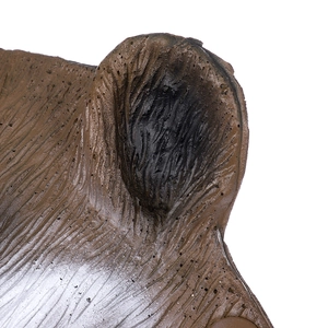 Macro shot showing the realistic fur texture and painted details of the brown animal mask