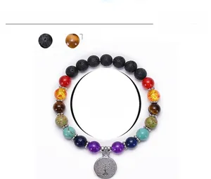 Macro detail of 8mm chakra lava stone bracelet with silver Tree of Life charm pendant