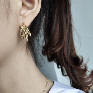 Elegance 925 sterling silver triple hoop earrings in gold finish worn by a model