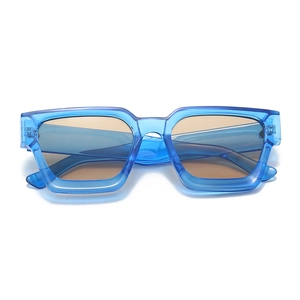 Close-up of trendy blue translucent square frame sunglasses with tinted lenses