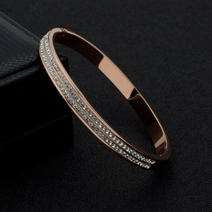Detail of rose gold stainless steel bracelet featuring double-row white rhinestones