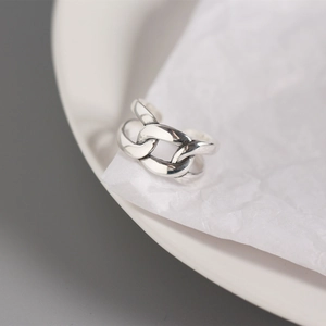 Macro shot of minimalist silver chain link ring with polished textured metal details