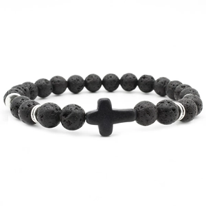 Lava stone bead bracelet with black cross and silver spacers on white background