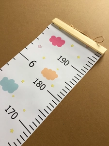 Detail view of canvas growth chart showing wooden hanger and 190cm scale markings
