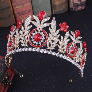 Close-up of golden crown with red and clear gems on vintage background