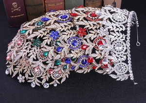 Detailed macro view of bridal crown featuring colorful rhinestones and intricate gold leaves