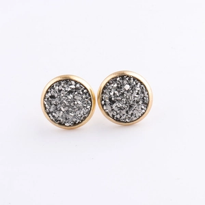 Macro shot of 10mm gold plated round stud earrings with shimmering silver mineral crystals