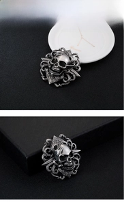 Detailed close-up of a gothic skull pendant made of polished stainless steel and silver