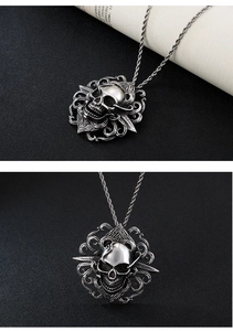 Detail view of a gothic skull pendant with intricate floral patterns and sword motifs