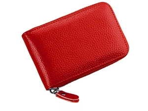 Side view of red pebble leather card holder with silver zipper and texture details