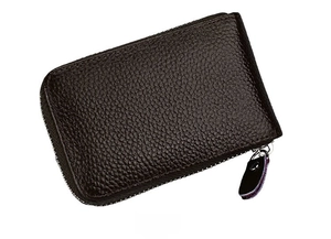 Side view of dark brown pebbled leather coin purse with metal zipper and pull tab detail