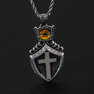 Retro shield cross pendant with yellow cat eye stone on a twist chain necklace